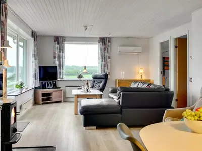 a living room with a couch and a table at Holiday Home Ephra - 250m to the fjord by Interhome in Roslev