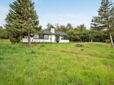 a white house in the middle of a field at Holiday Home Kaleva - 200m to the fjord by Interhome in Fur