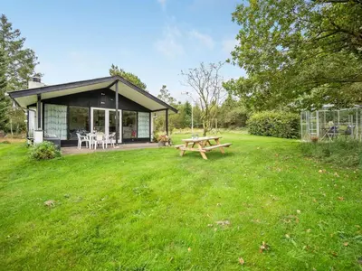 a house with a picnic table in the grass at Holiday Home Kaleva - 200m to the fjord by Interhome in Fur