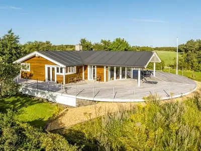a house with a large deck in front of it at Holiday Home Eljas - 200m to the fjord by Interhome in Fur