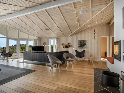 a living room with a piano and chairs at Holiday Home Eljas - 200m to the fjord by Interhome in Fur