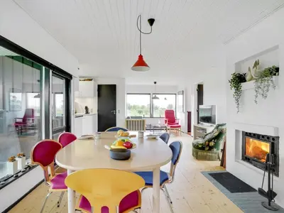 a kitchen and dining room with a table and chairs at Holiday Home Clarita - 300m to the fjord by Interhome in Roslev