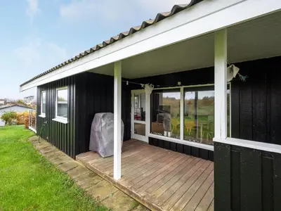 a covered deck on the side of a house at Holiday Home Clarita - 300m to the fjord by Interhome in Roslev