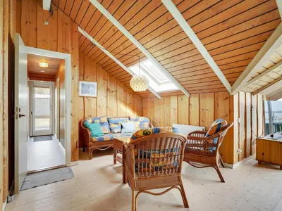 a living room with a table and chairs at Holiday Home Henrieke - 250m to the fjord by Interhome in Roslev