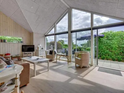 a living room with a large window and a couch at Holiday Home Regni - 300m to the fjord by Interhome in Nykøbing Mors