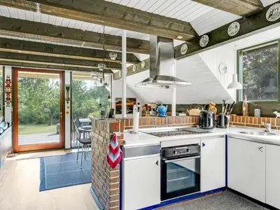 a kitchen with white counters and a stove top oven at Holiday Home Paale - 200m to the fjord by Interhome in Fur