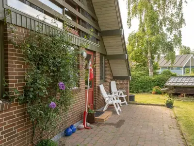a brick house with two chairs on a patio at Holiday Home Paale - 200m to the fjord by Interhome in Fur