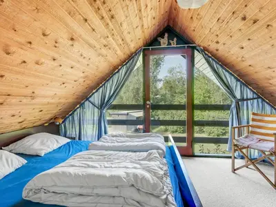 two beds in a room with a wooden ceiling at Holiday Home Paale - 200m to the fjord by Interhome in Fur