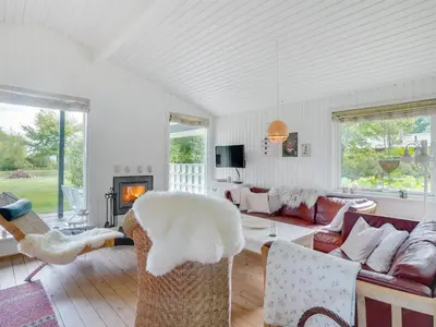 a living room with a couch and a fireplace at Holiday Home Suoma - 400m to the fjord by Interhome in Roslev