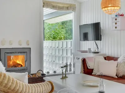 a living room with a fireplace and a tv at Holiday Home Suoma - 400m to the fjord by Interhome in Roslev