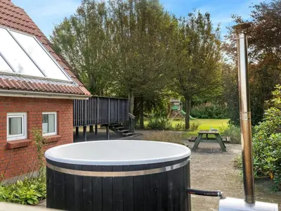 a hot tub in the backyard of a house at Holiday Home Auguste - 1-5km to the fjord by Interhome in Fur