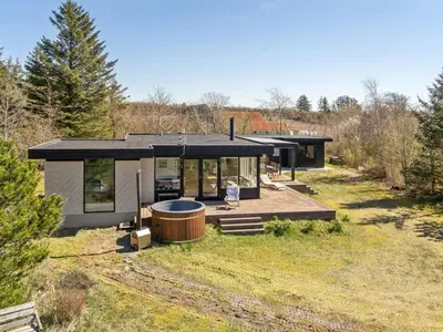 a house with a hot tub in the yard at Holiday Home Lefke - 400m to the fjord by Interhome in Roslev