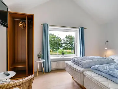 a bedroom with a bed and a window at Holiday Home Rina - 30m to the fjord by Interhome in Fur