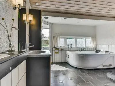 a large bathroom with a large tub and a sink at Holiday Home Sylvelin - 400m to the fjord by Interhome in Roslev