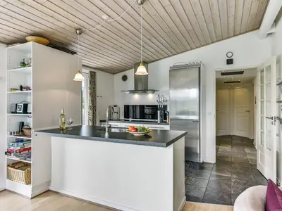 a kitchen with a counter top and a refrigerator at Holiday Home Sylvelin - 400m to the fjord by Interhome in Roslev