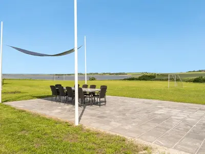 a table and chairs sitting on top of a patio at Holiday Home Imilie - 250m to the fjord by Interhome in Redsted
