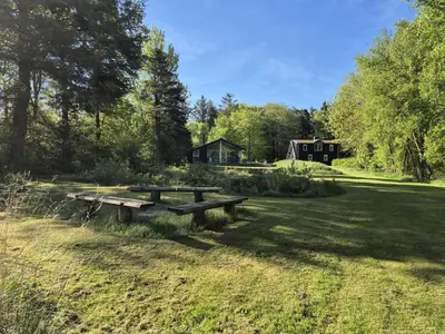 a picnic table in the middle of a field at Holiday Home Aswarth - 50m to the fjord by Interhome in Fur
