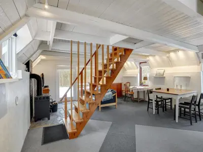 a staircase in a room with a table and chairs at Holiday Home Aswarth - 50m to the fjord by Interhome in Fur