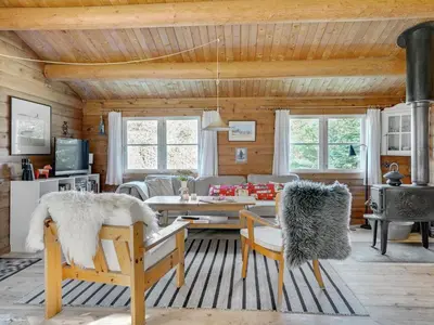 a living room with a couch and a table at Holiday Home Thrine - 100m to the fjord by Interhome in Fur