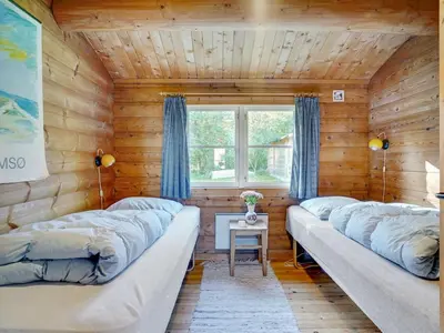 a room with two large couches in a wooden wall at Holiday Home Thrine - 100m to the fjord by Interhome in Fur