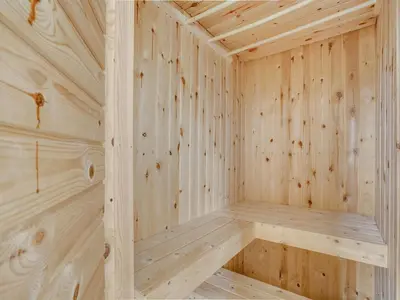 a wooden sauna with wooden walls and ceilings at Holiday Home Gren - 90m to the fjord by Interhome in Roslev