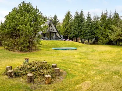 a green frisbee in the yard of a house at Holiday Home Brunhild - 300m to the fjord by Interhome in Fur