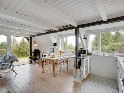 a kitchen and living room with a table and chairs at Holiday Home Brunhild - 300m to the fjord by Interhome in Fur