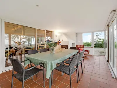 a dining room with a table and chairs at Holiday Home Emmie - 50m to the fjord by Interhome in Skarum