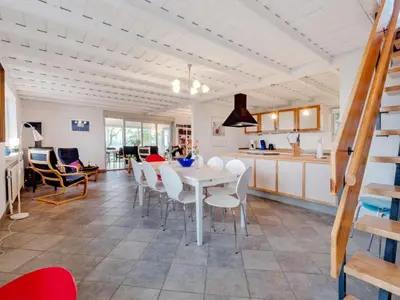 a kitchen and dining room with a table and chairs at Holiday Home Emmie - 50m to the fjord by Interhome in Skarum