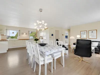 a kitchen and dining room with a table and chairs at Holiday Home Mikkeline - 400m to the fjord by Interhome in Øster Assels