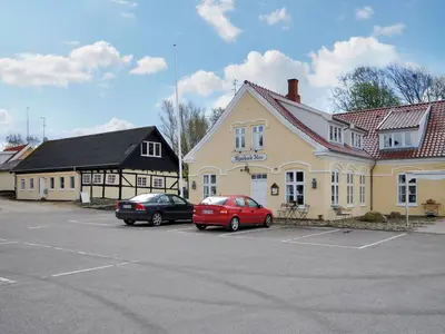 two cars parked in a parking lot in front of a building at Holiday Home Imgert - 300m to the fjord by Interhome in Løgstrup