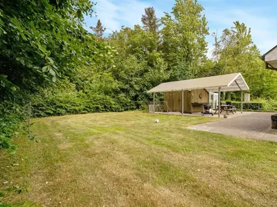 a gazebo with a picnic table in a yard at Holiday Home Ødger - 150m to the fjord by Interhome in Åbybro
