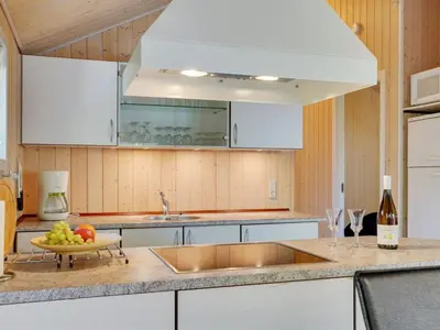 a kitchen with white cabinets and a plate of fruit at Holiday Home Jussi - 3-5km from the sea by Interhome in Brovst