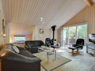 a living room with a leather couch and a tv at Holiday Home Jussi - 3-5km from the sea by Interhome in Brovst