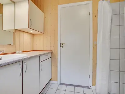 a kitchen with white cabinets and a white door at Holiday Home Jussi - 3-5km from the sea by Interhome in Brovst