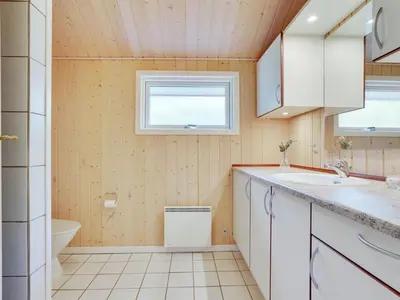 a bathroom with a sink and a toilet at Holiday Home Jussi - 3-5km from the sea by Interhome in Brovst