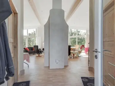 a living room with a pillar in the middle of a room at Holiday Home Ullvi - 3-8km from the sea by Interhome in Brovst