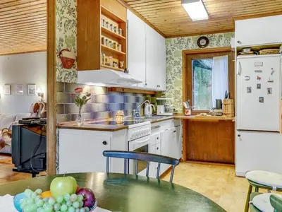 a kitchen with white appliances and a table with fruit on it at Holiday Home Carina - 5km from the sea by Interhome in Brovst