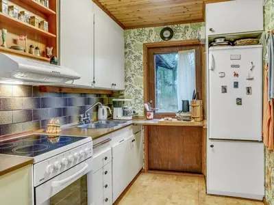 a kitchen with white appliances and a white refrigerator at Holiday Home Carina - 5km from the sea by Interhome in Brovst