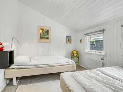 a bedroom with two beds and a window at Holiday Home Eske - 200m to the fjord by Interhome in Åbybro