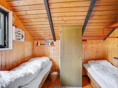 a small room with two beds in a cabin at Holiday Home Tenho - 4-4km from the sea by Interhome in Brovst