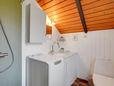a bathroom with a sink and a toilet at Holiday Home Tenho - 4-4km from the sea by Interhome in Brovst