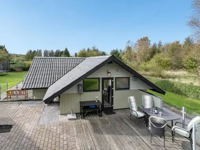 a small house with a roof on a patio at Holiday Home Tenho - 4-4km from the sea by Interhome in Brovst