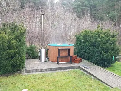a small wooden structure with a table in a yard at Holiday Home Tenho - 4-4km from the sea by Interhome in Brovst