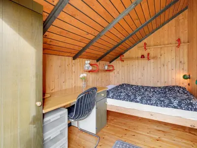 a small room with a bed and a desk at Holiday Home Tenho - 4-4km from the sea by Interhome in Brovst