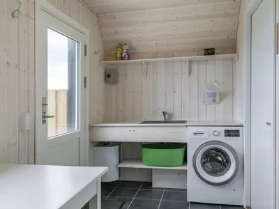 a small kitchen with a washing machine and a sink at Holiday Home Viona - 350m from the sea by Interhome in Pandrup