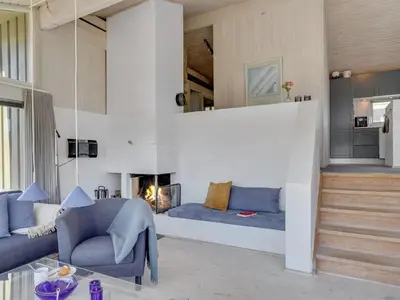 a living room with a couch and a fireplace at Holiday Home Fanney - 100m from the sea by Interhome in Pandrup