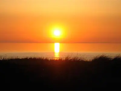 a sunset over the ocean with the sun setting at Holiday Home Tinea - 50m from the sea by Interhome in Pandrup