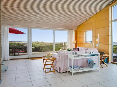 a living room with a couch and a table at Holiday Home Tinea - 50m from the sea by Interhome in Pandrup
