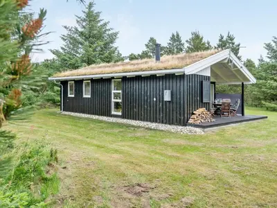 a black tiny house with a grass roof at Holiday Home Svantepolk - 1-1km from the sea by Interhome in Pandrup